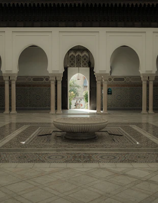 Traditional riad courtyard with lush greenery and intricate tilework.