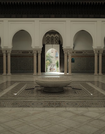 An elegant courtyard inside the Marrakech riad showcasing traditional tilework and lush greenery.