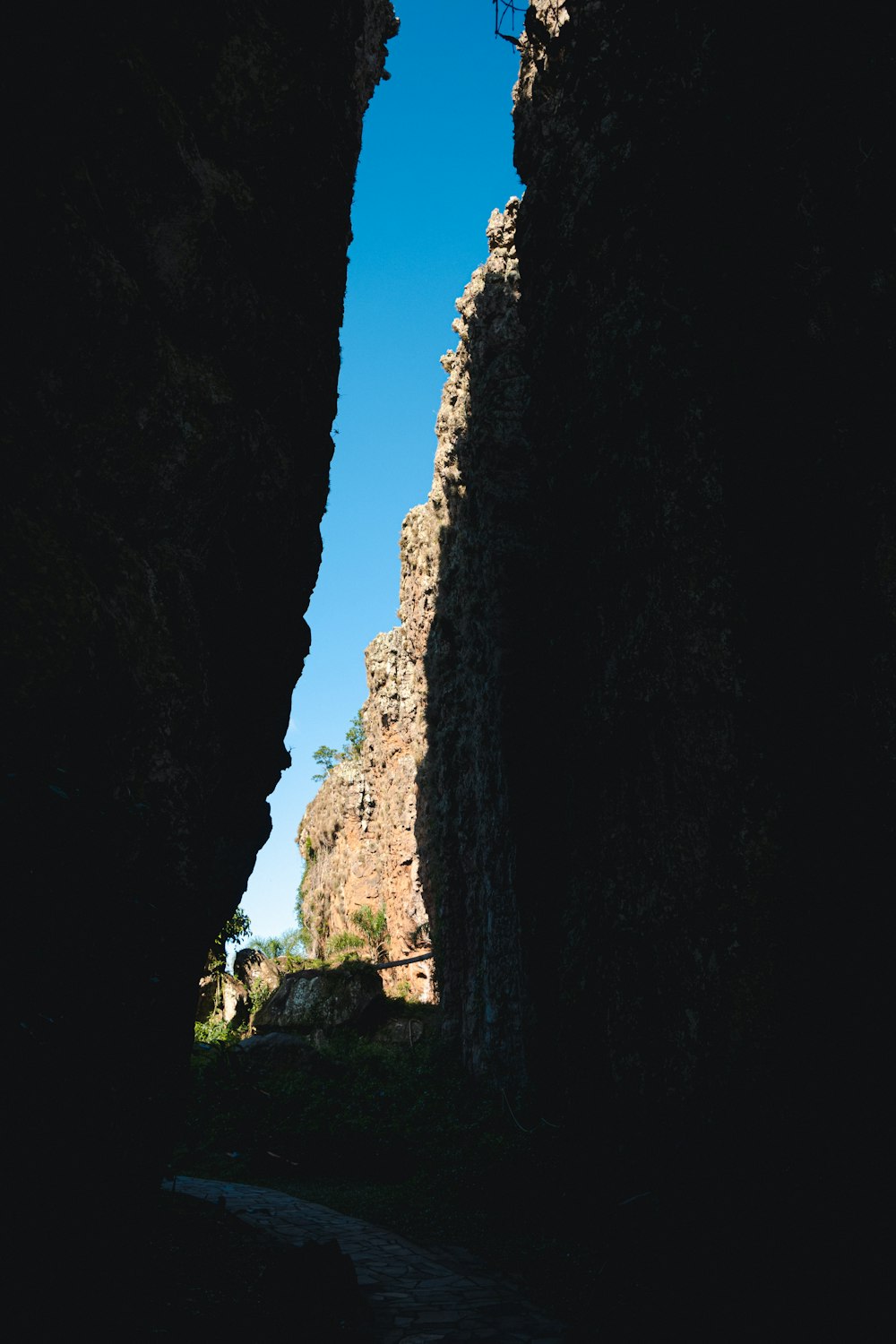 a person walking through a tunnel in a canyon