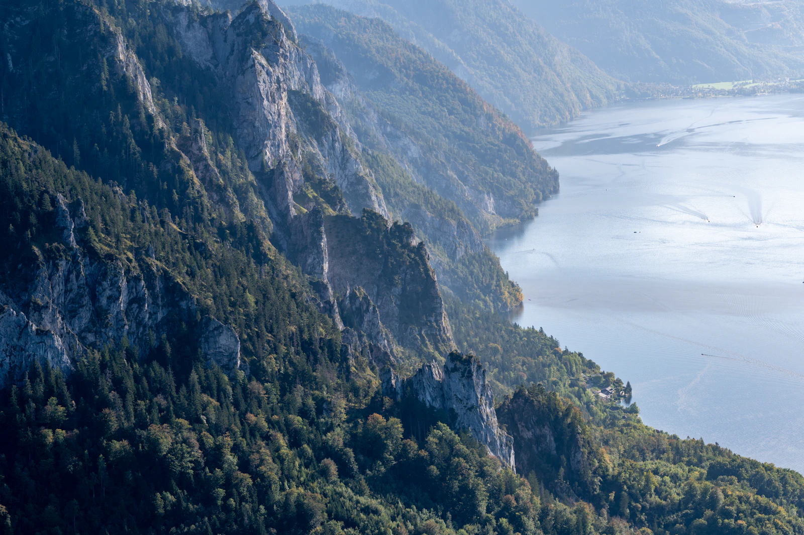 Photograph of High view across the steep eastern shore of Traunsee towards Gmunden and the northern end of the lake.