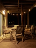 A cozy patio with string lights and outdoor seating.