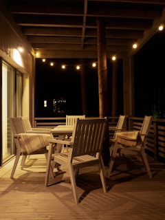 A cozy farmhouse patio at sunset with warm lights and comfortable seating.