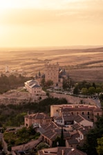 A romantic sunset view of Villa del Cardinale overlooking Lake Albano with soft golden light.