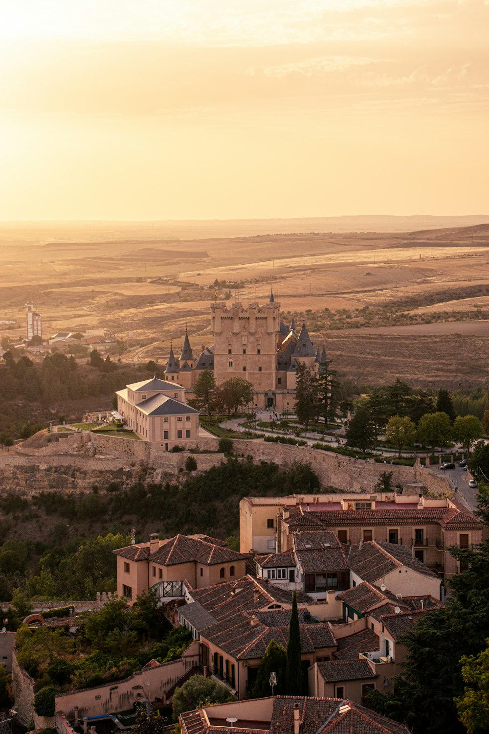 a view of a town with a castle in the background