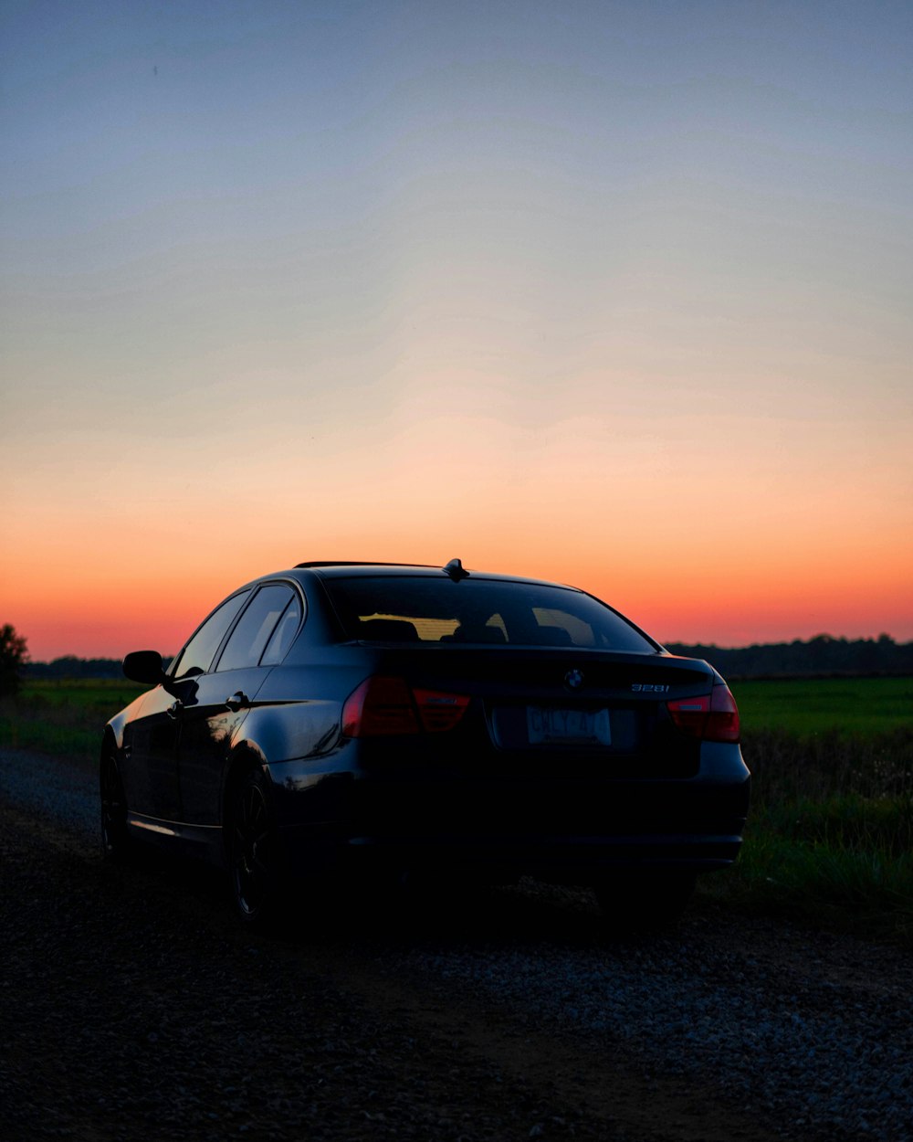 a car parked on the side of a dirt road