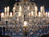 A crystal chandelier casting sparkling reflections in a cozy living room.