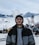 a man standing in front of a snow covered ski slope