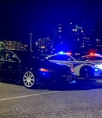 A night scene of a tow truck with flashing lights.