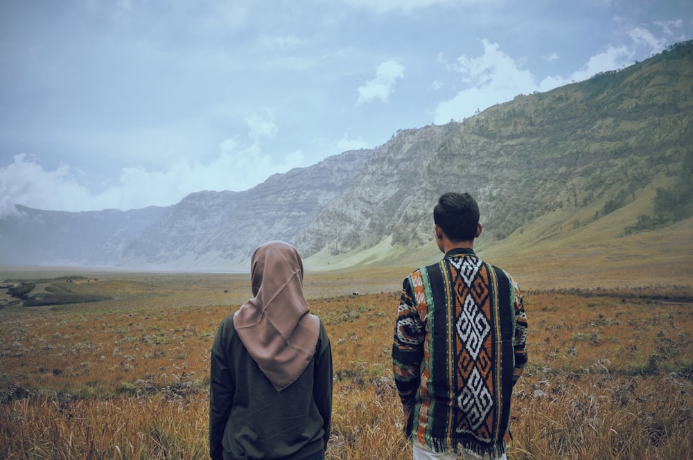 a couple of people standing in a field