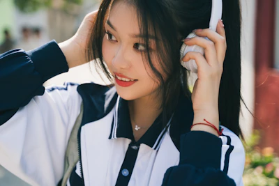 A comforting scene of a person smiling gently while listening through headphones.