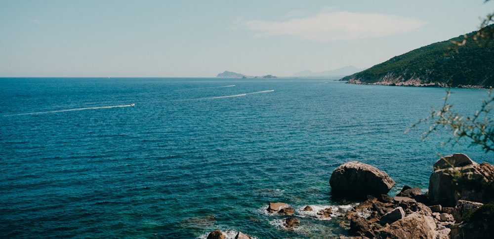 a boat is out in the ocean on a sunny day