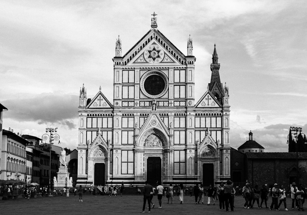 a group of people standing in front of a church