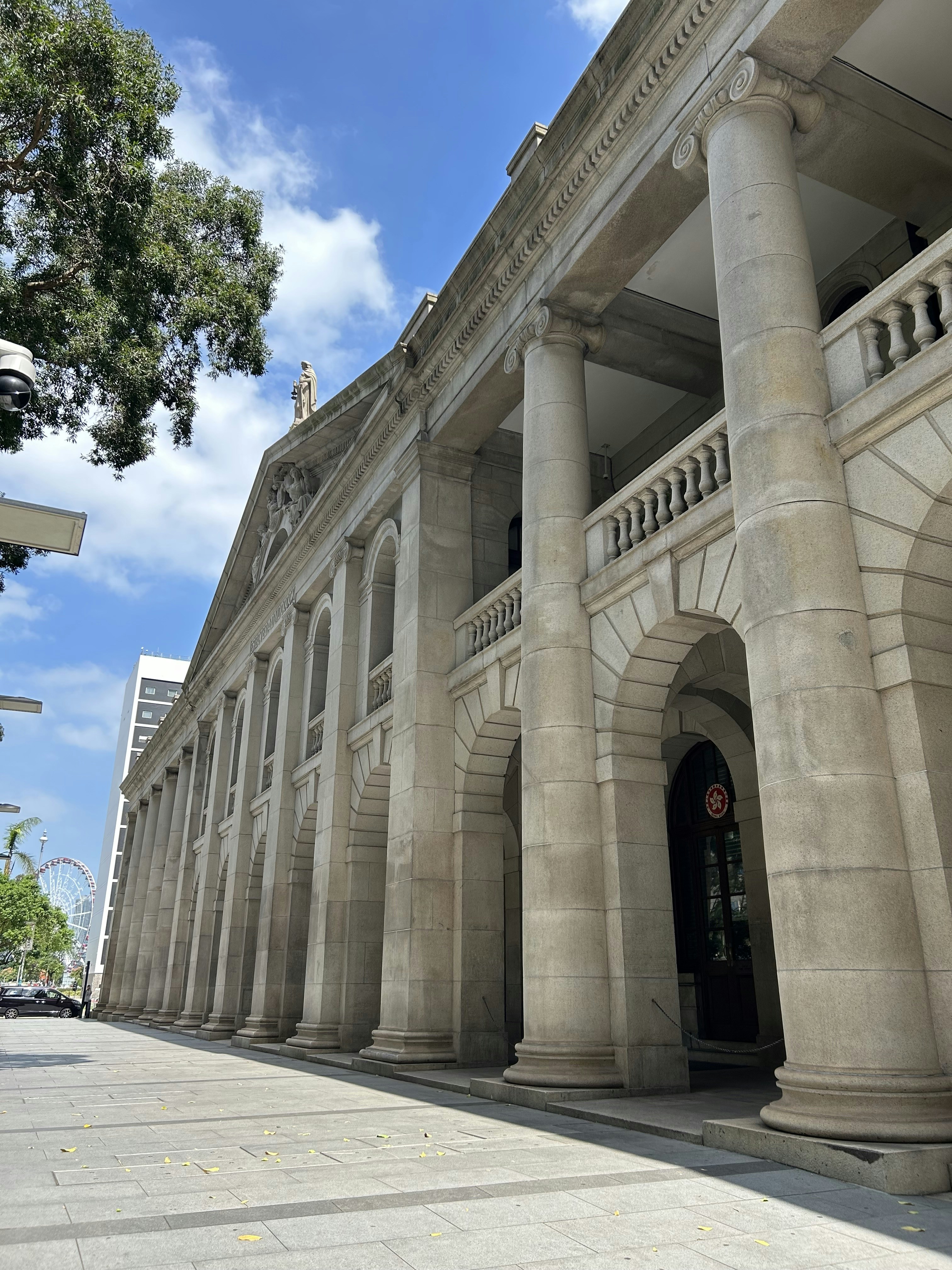 Un gran edificio con columnas y un reloj en la parte delantera