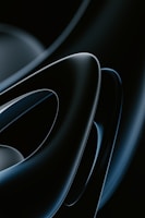 Smooth, glossy, abstract shapes in a dark color palette with overlapping curves and a futuristic appeal.