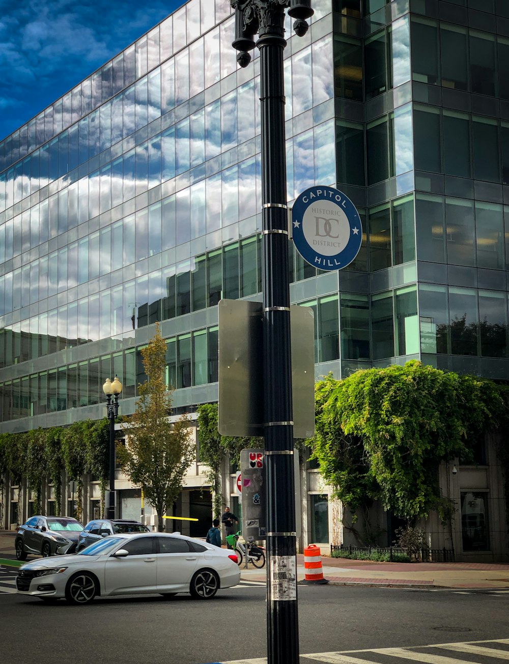 a pole with a street sign on it in front of a building