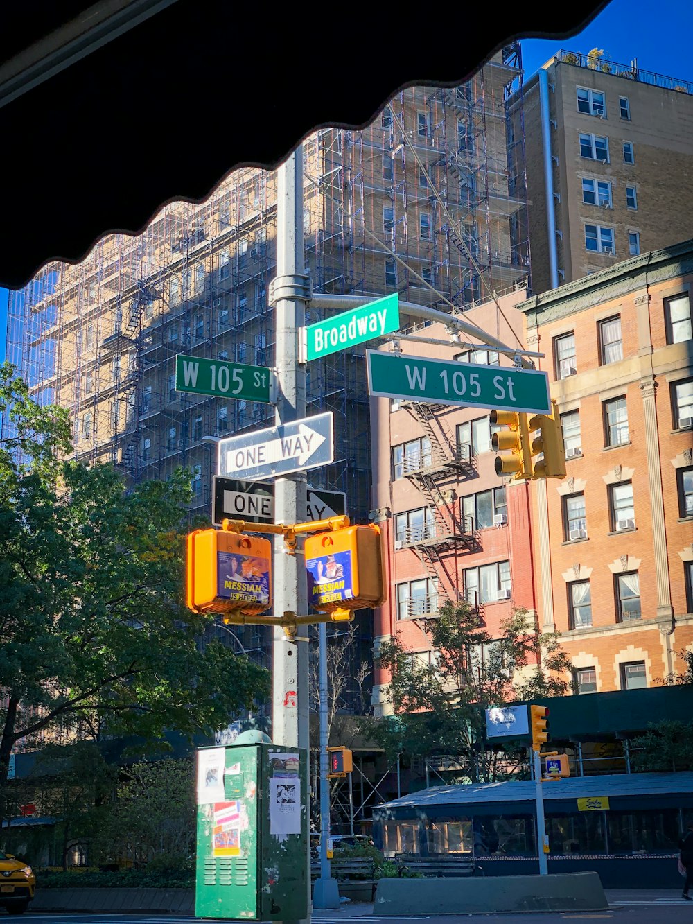 a pole with street signs and a traffic light