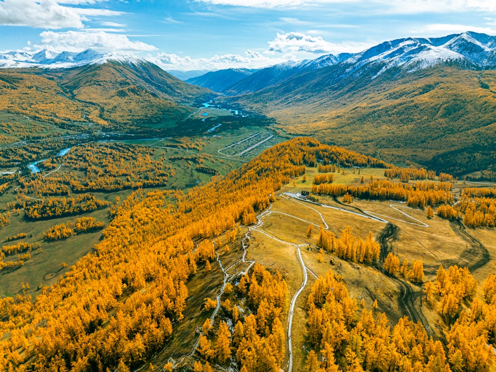 an aerial view of a valley surrounded by mountains