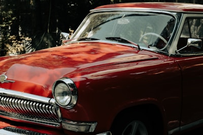 A vintage car with shiny new paint and detailed craftsmanship.