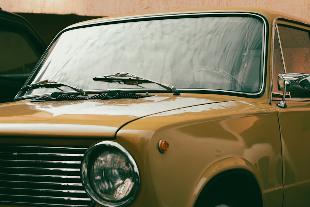 a yellow car parked next to a building