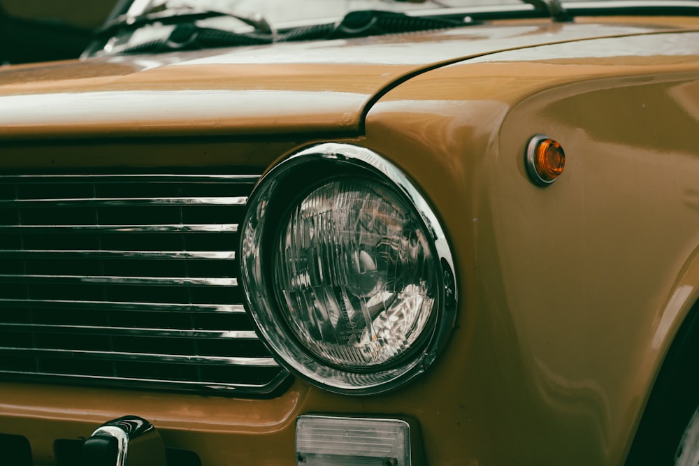 a close up of the front of a yellow car