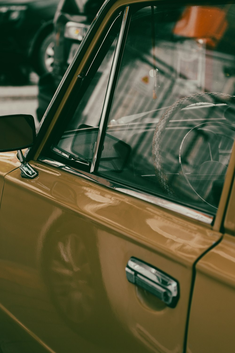 a yellow car parked on the side of the road