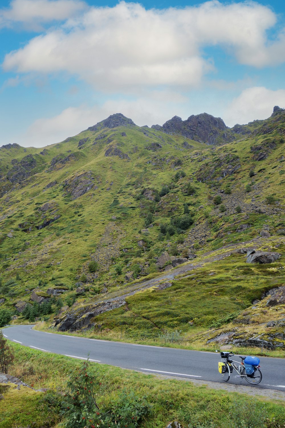 a man riding a motorcycle down a curvy road