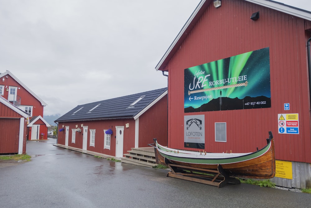 a red building with a boat in front of it