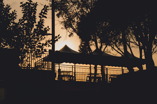 Sunset view over the retreat grounds with tents and trees silhouetted against the sky.