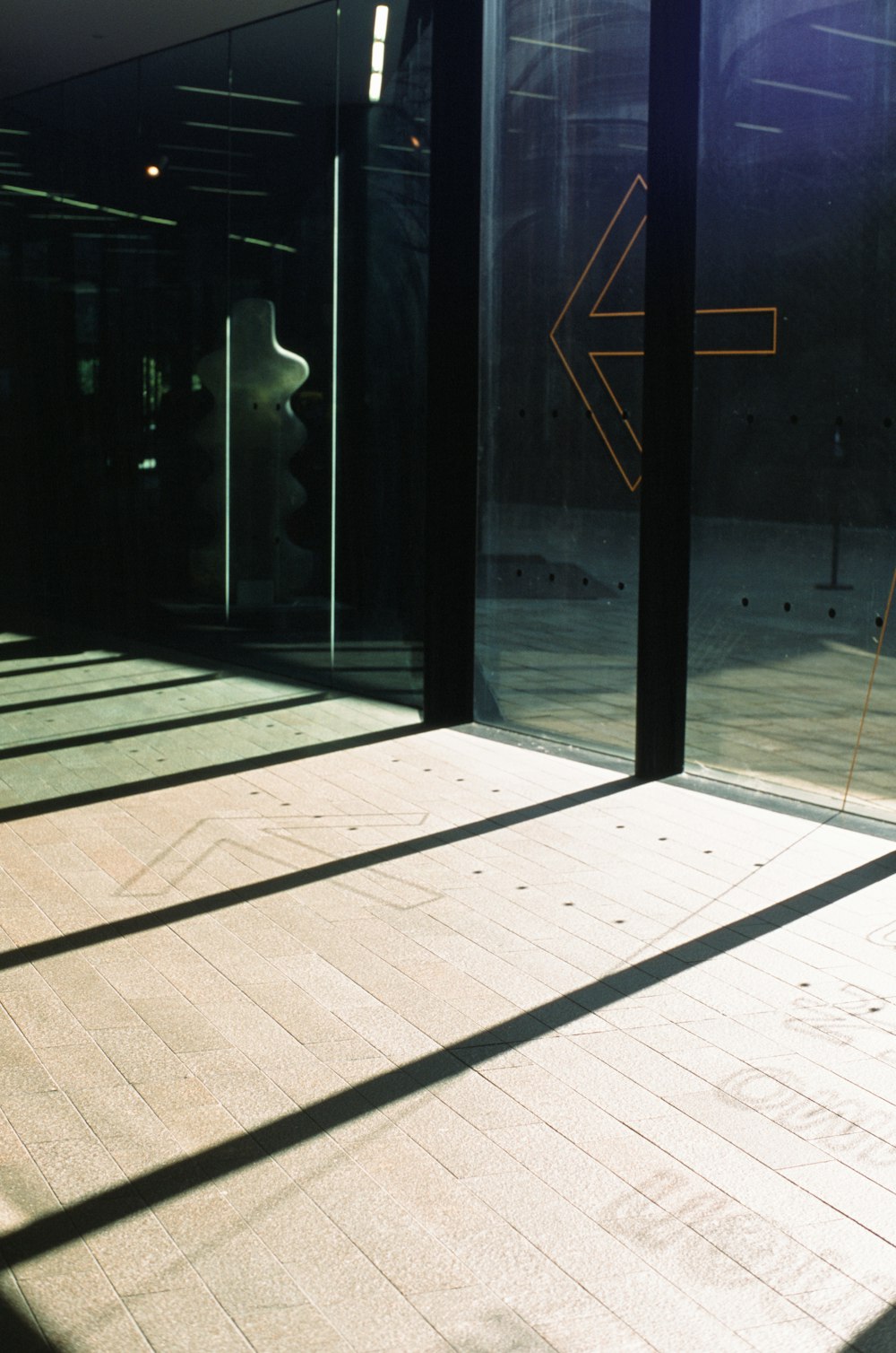 a person walking down a sidewalk in front of a building