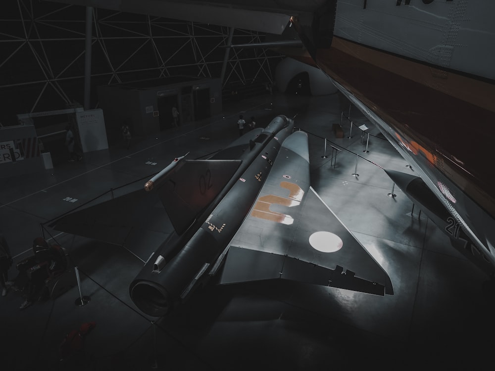 a fighter jet is on display in a museum