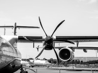 a large propeller airplane sitting on top of an airport tarmac