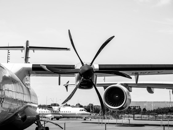 a large propeller airplane sitting on top of an airport tarmac