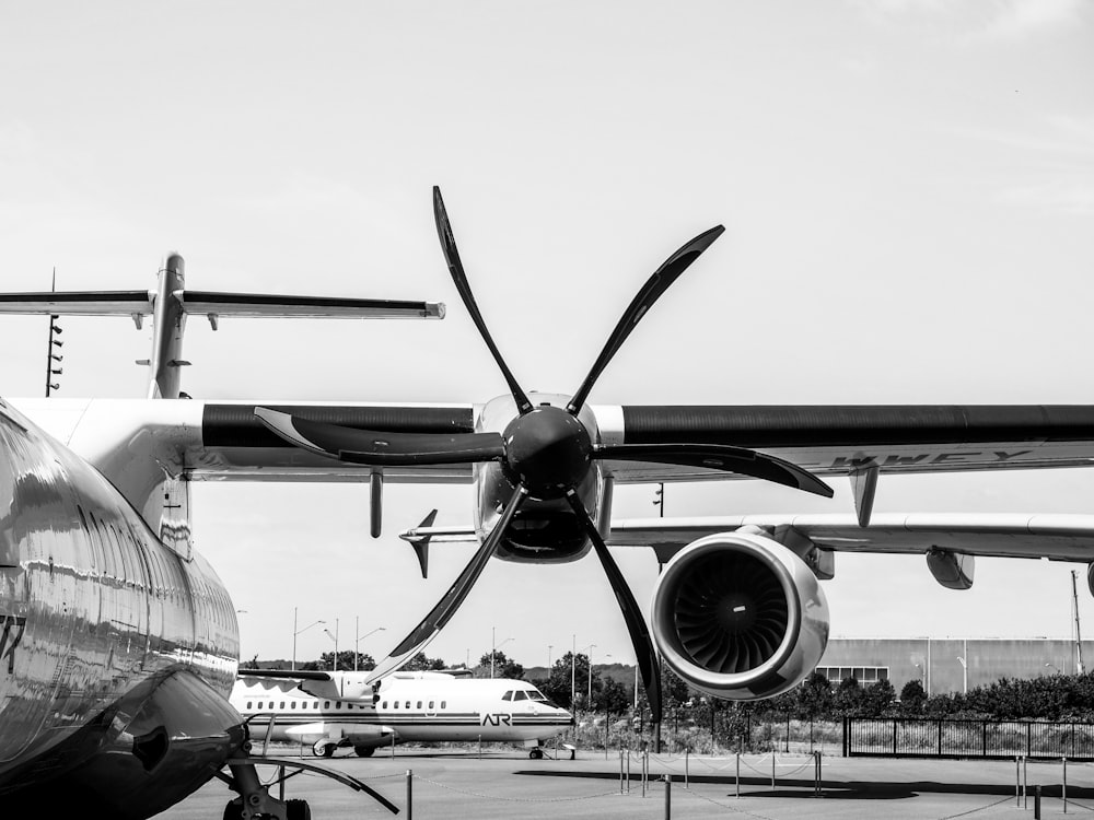 a large propeller airplane sitting on top of an airport tarmac