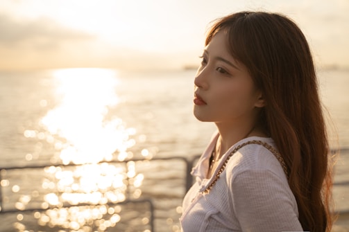 A serene woman using a clairvoyance app outdoors at sunset