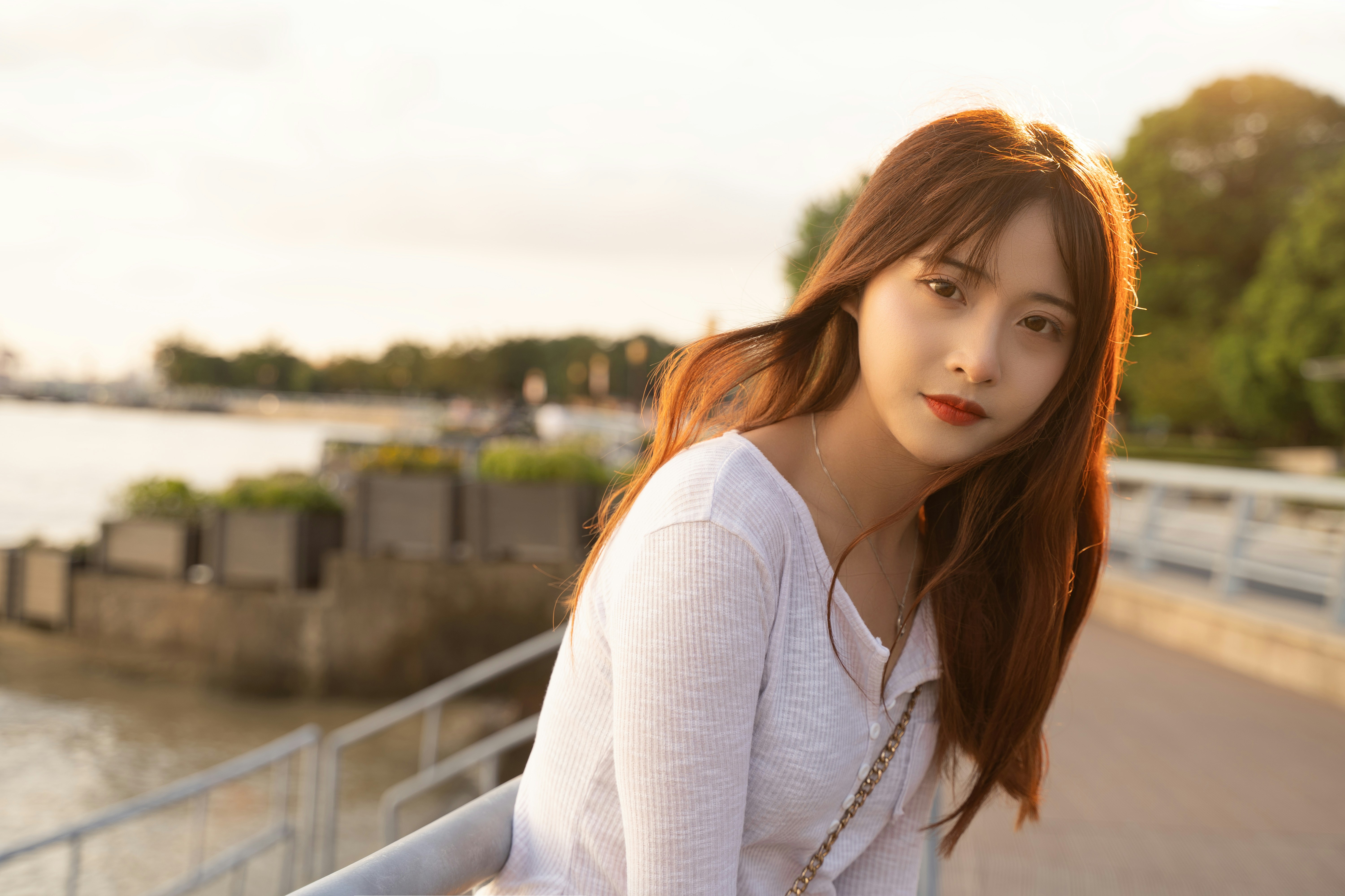 A woman with long red hair standing on a bridge photo – Free Portrait ...