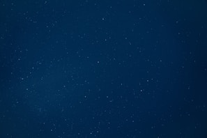 White stars scattered across a dark blue canvas, evoking a sense of calm and guidance.