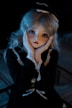 A doll-like figure with large, expressive eyes and long, blonde hair is posed with hands gently holding its face. The figure wears a dark, elegant dress with lace trim and a matching bow atop its head. The lighting casts a soft glow, emphasizing the delicate features and creating a mysterious ambiance.