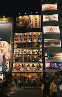 A bustling market street in Tokyo lit up at night, showcasing the excitement of international travel.