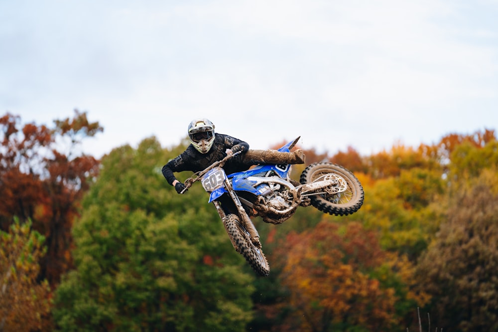 a man riding a dirt bike through the air