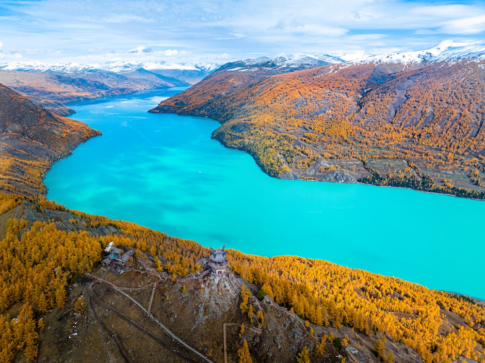 an aerial view of a lake surrounded by mountains