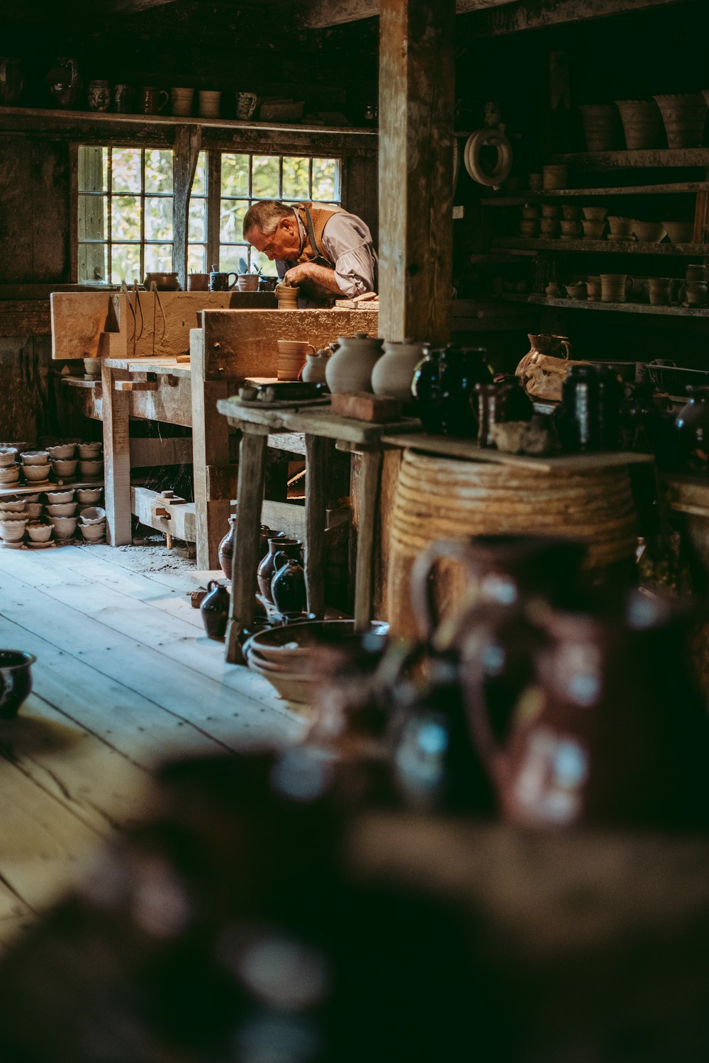 a man is working in a pottery shop