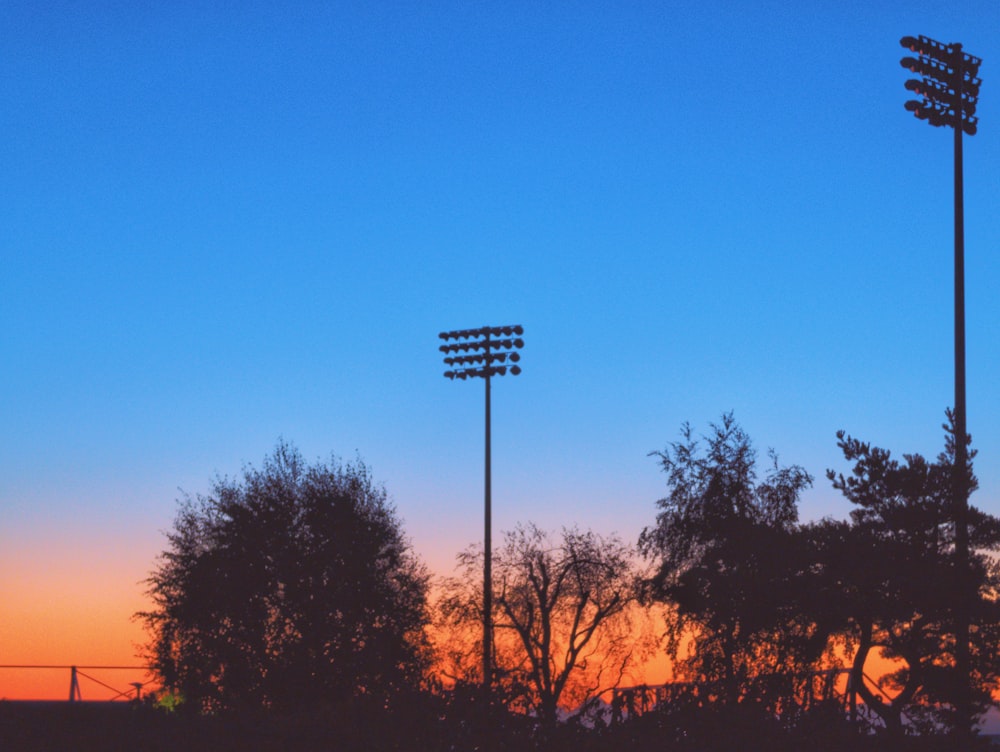 a baseball field with a sunset in the background