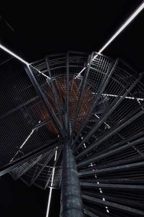 A detailed 3D steel stair design rendered against a dark background, showcasing precision and engineering imagination.