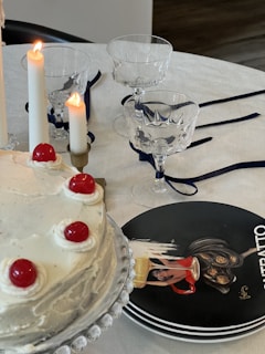 A beautifully arranged table with an elegant cake and fresh flowers.