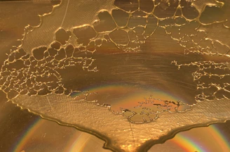 Close-up of golden candied honey crystals glistening under soft light