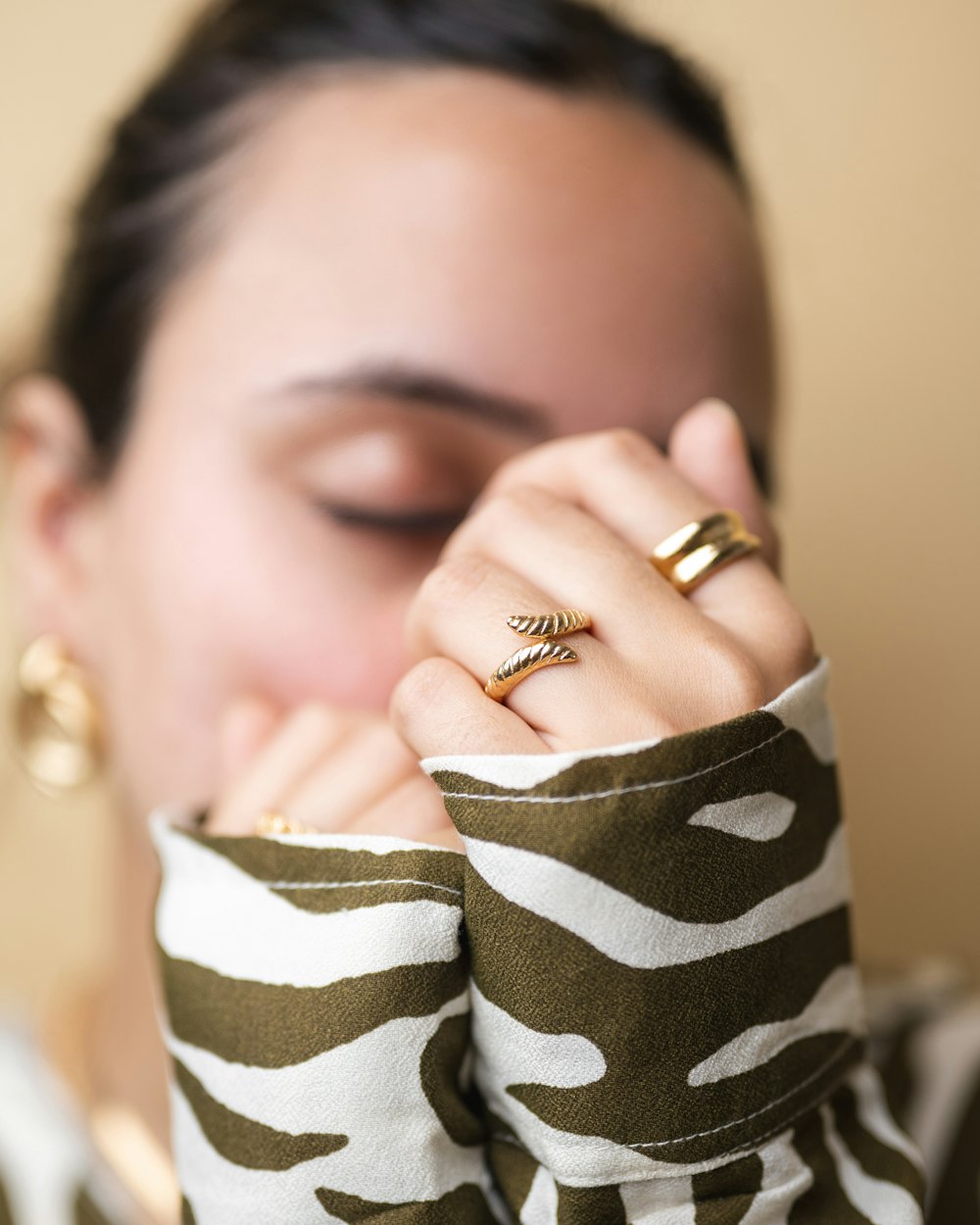 a woman holding her hand up to her face