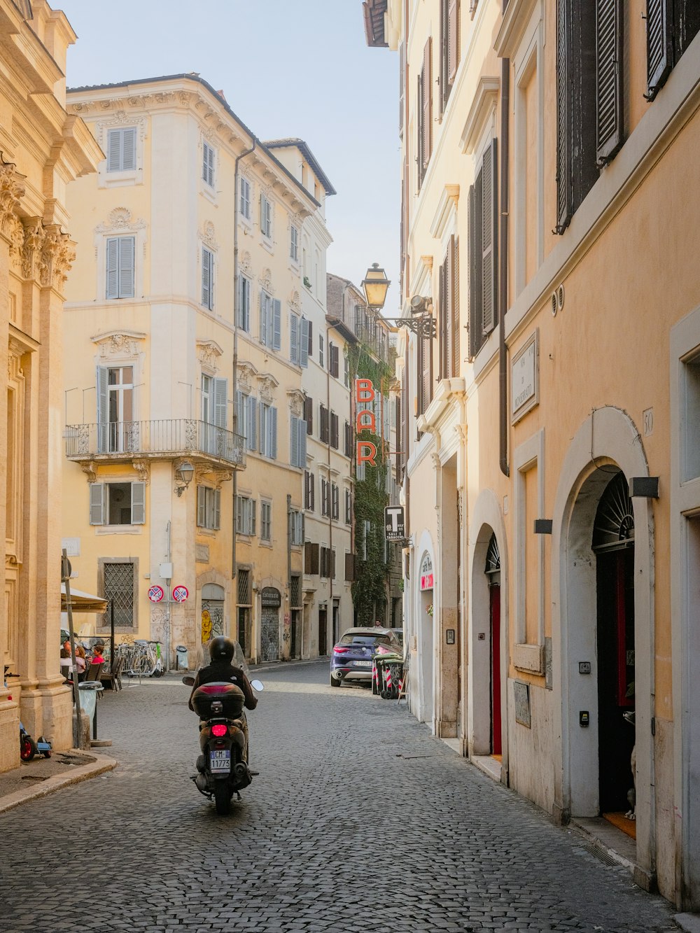 a motorcycle is parked on a cobblestone street