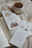 A cozy scene with a crochet pouch placed beside a cup of tea and a book.