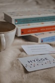 A cozy setup with a handmade mug and a stack of thoughtful books wrapped as a gift.