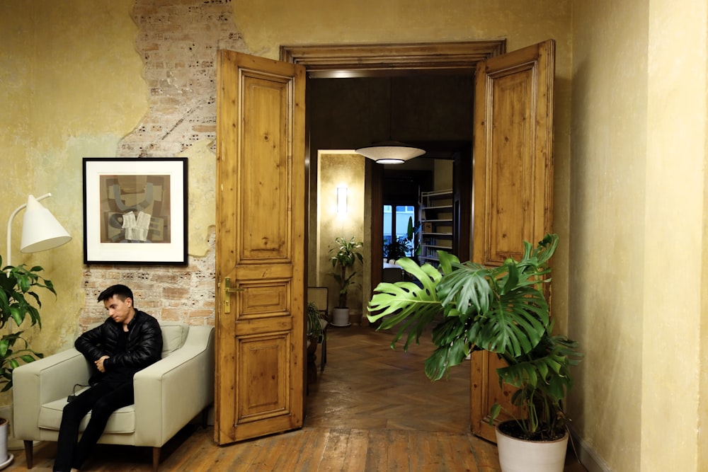 a man sitting on a chair in a room